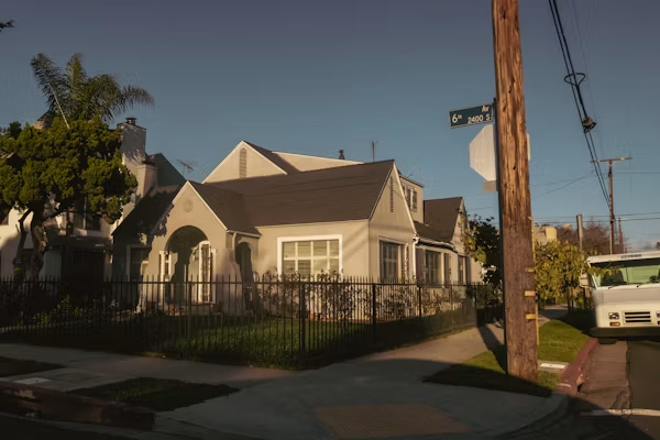 Professional roofing contractor in California inspecting a home roof