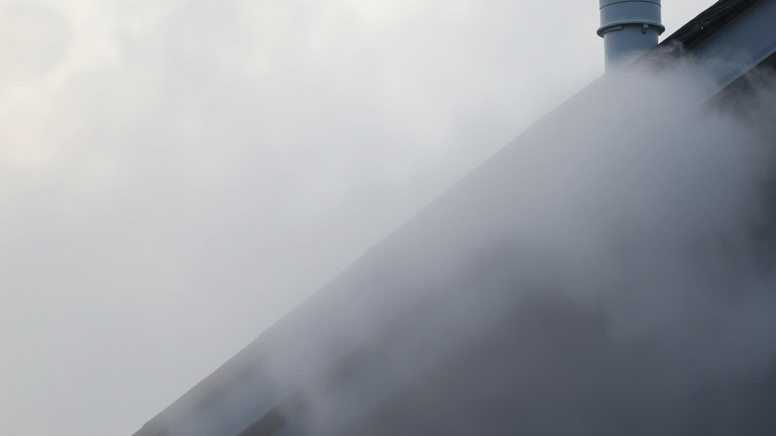 Dense winter tule fog settling over a Fresno rooftop and plumbing vent pipe boot