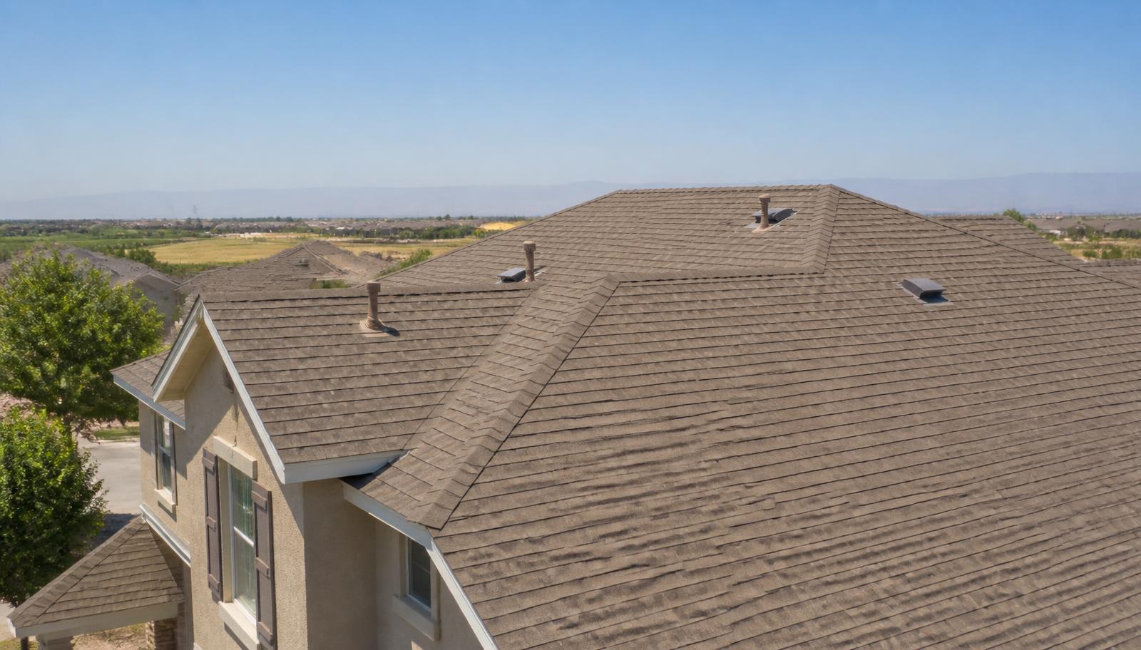 Architectural asphalt shingle roof on a Central Valley home under intense summer heat