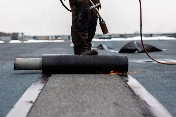 Commercial TPO roofing in California being installed on a low-slope building