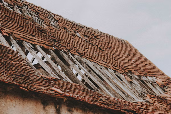 Severely damaged and missing shingles in a Fresno home.