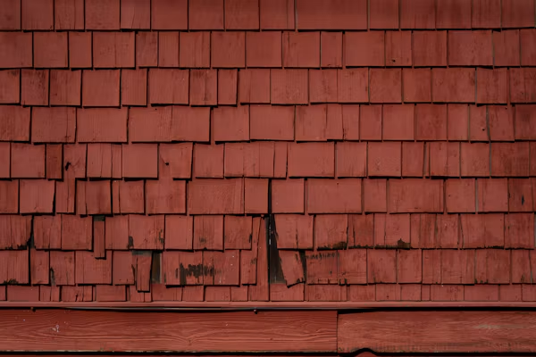 Cracked and curling roof shingles requiring roofing services in Fresno.
